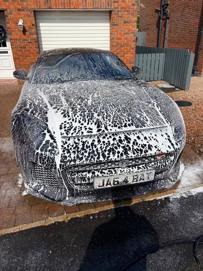 Jaguar covered in snow foam during wash